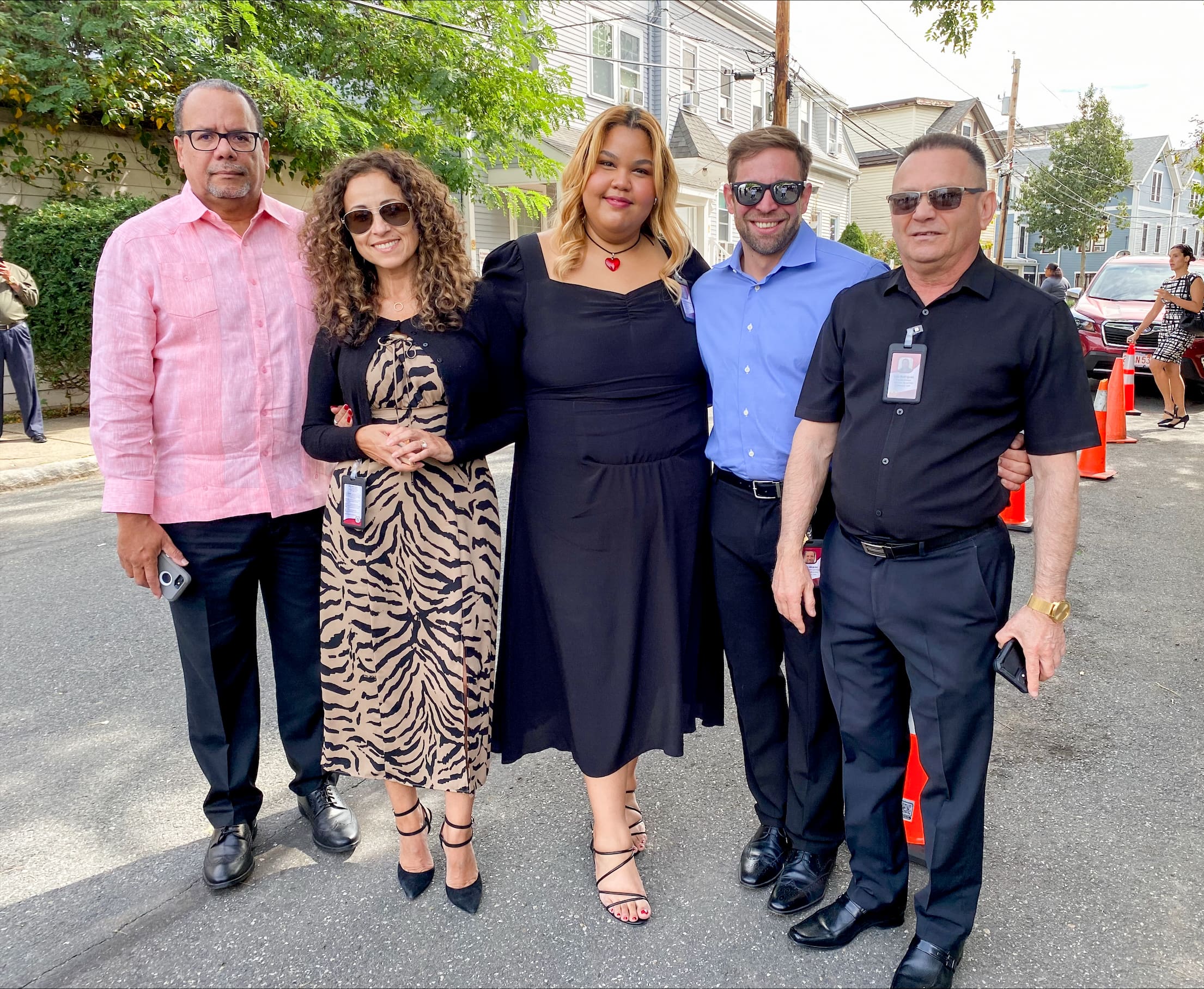 Three men and two women smiling. The group of people represents unity and support at Casa